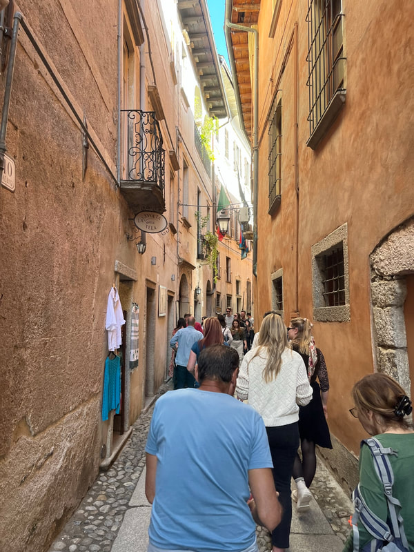 Small Italian street with tourists. 