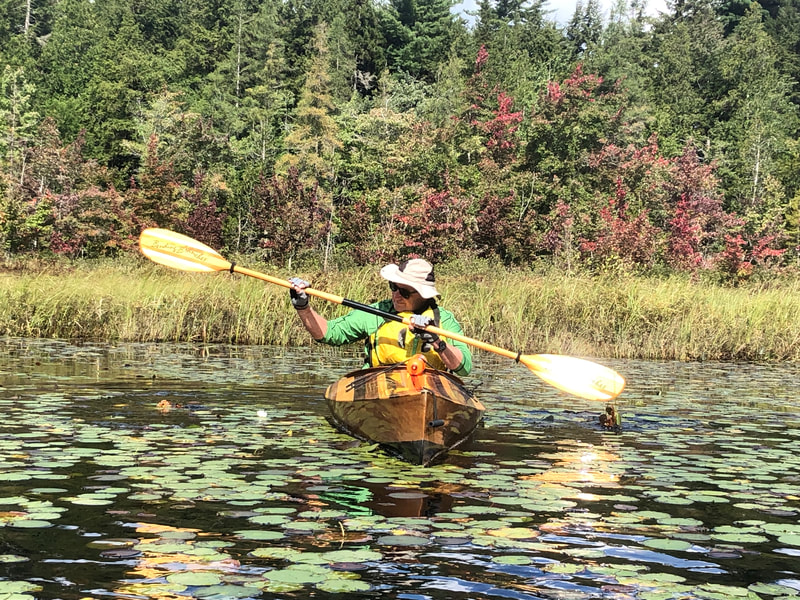 Kayaker with water lily