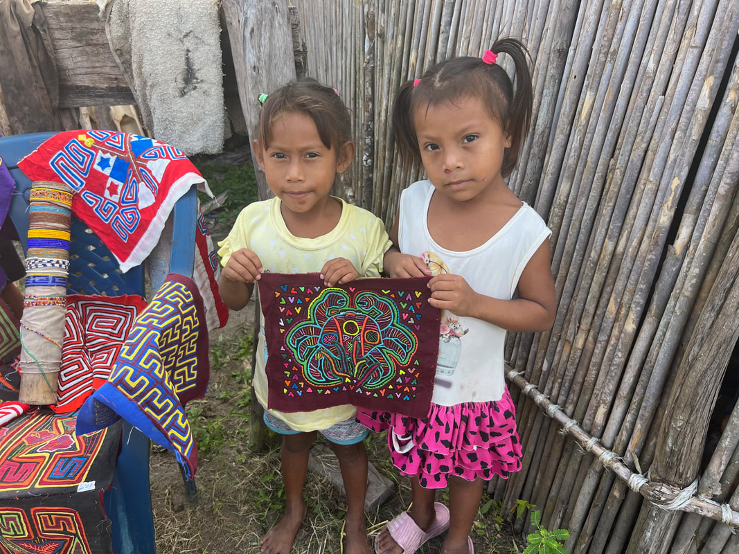 Kuna children holding a mola